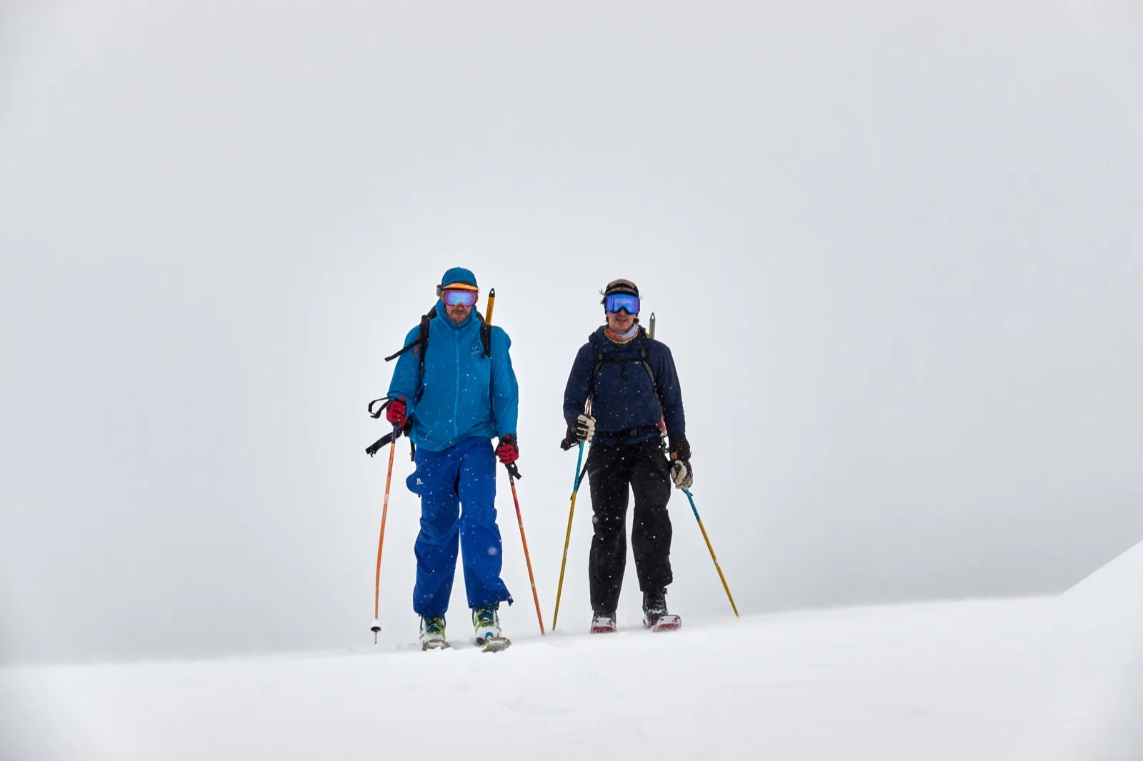 Skiers ascending in whiteout